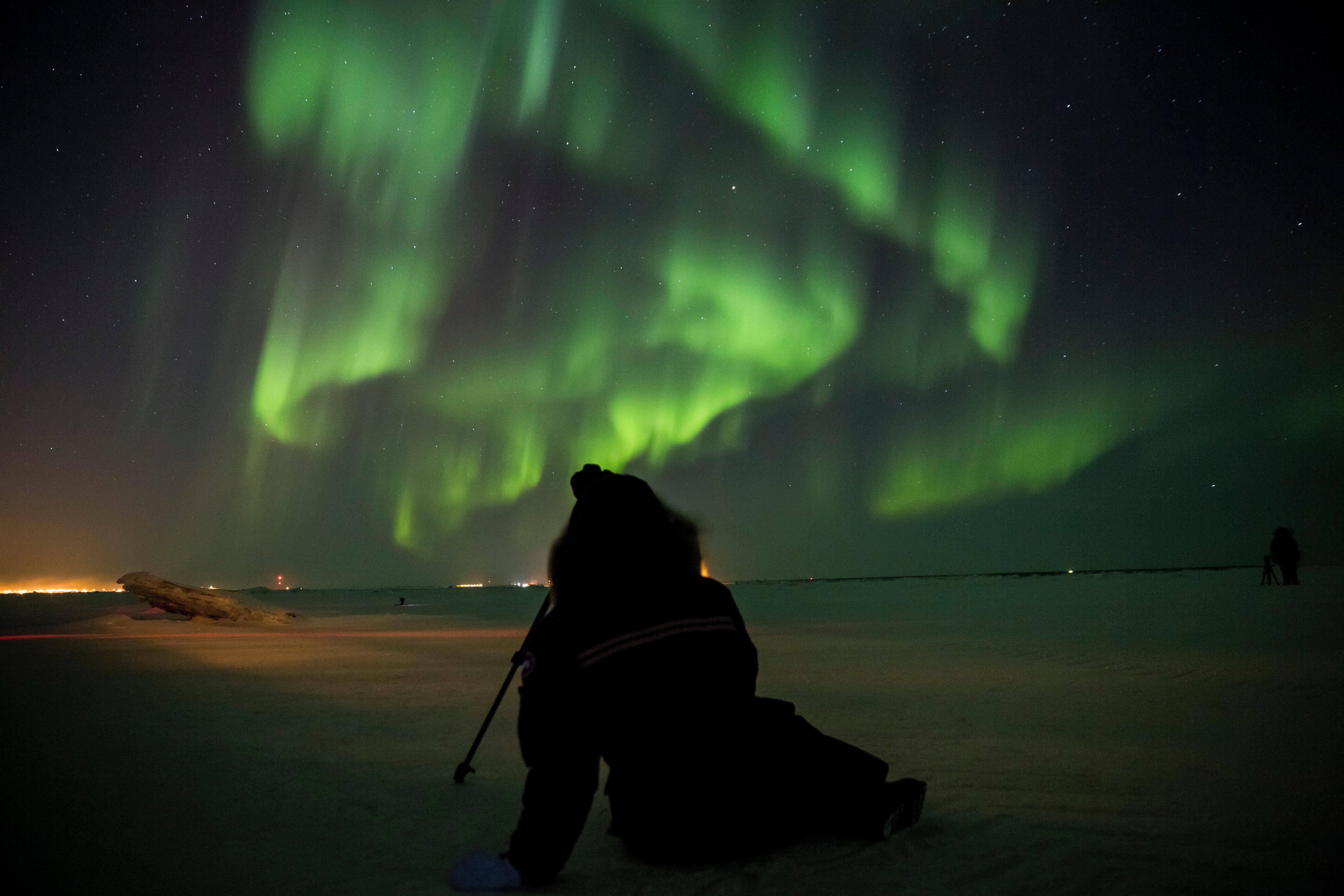 Sitting on the frozen tundra in Churchill, Manitoba enjoying the northern lights outside of Frontiers North's  Dan's Diner.