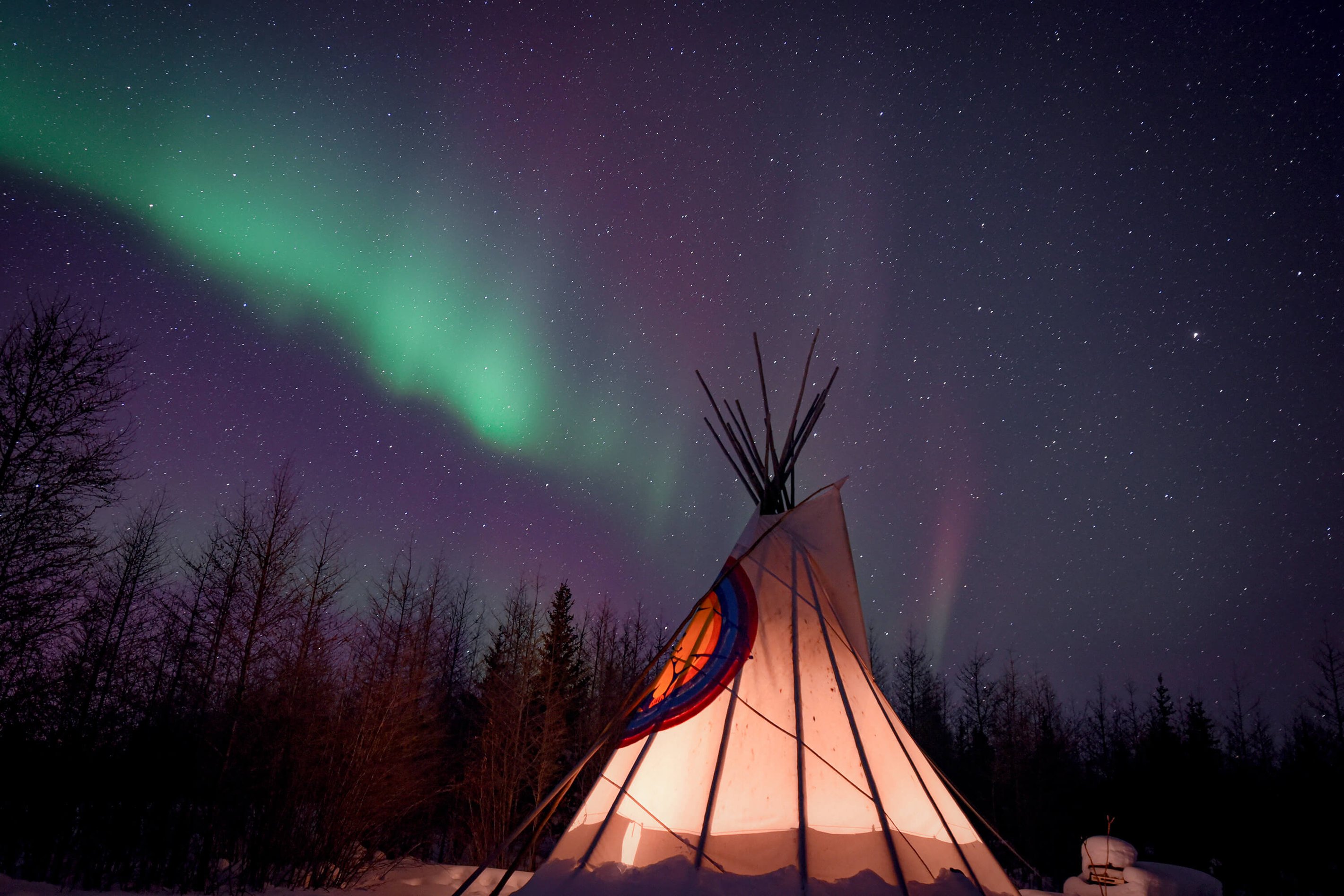The northern lights shining above a teepee in Churchill, Canada