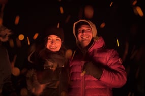 A couple drinking scotch under the northern lights in Churchill, Manitoba