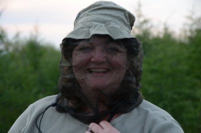 Woman in netting to avoid mosquitos. 