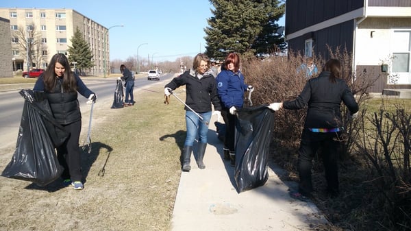 Frontiers North team members helping clean up a park for Earth Day.