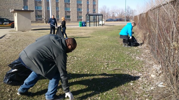 Frontiers North team members helping clean up a park for Earth Day.