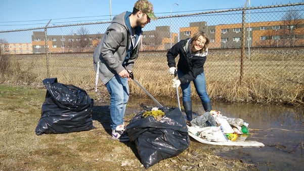 Frontiers North team members helping clean up a park for Earth Day.