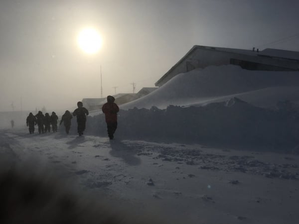 A brave group of souls pass by the buried Tundra Inn Pub.