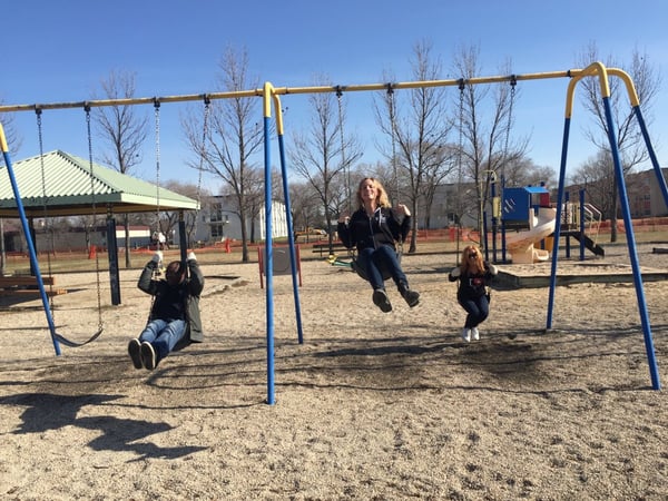 Frontiers North team members helping clean up a park for Earth Day.