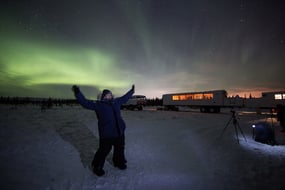 A person standing on the tundra in Churchill, Canada after the Dan's Diner culinary experience.