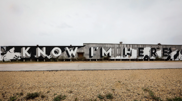 A large mural reading "Know I'm Here" is painted on a building in Churchill, MB