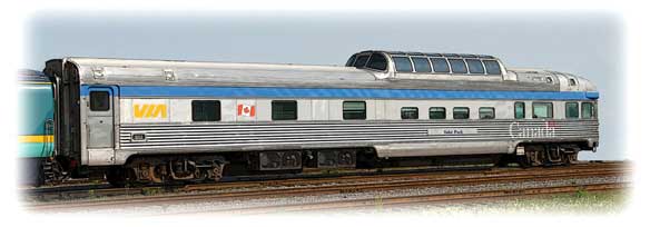 A VIA Rail park car at rest on tracks.